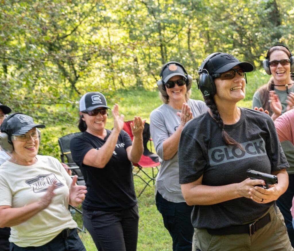 women cheering on someone at shooting range